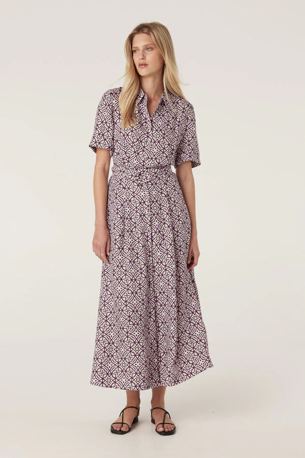 Woman wearing a patterned dress on a white background